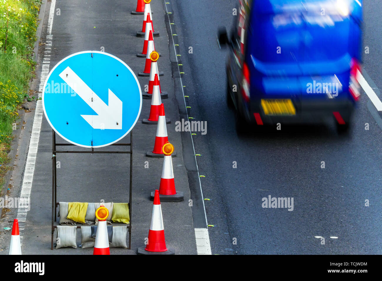 UK Road Services Roadworks Cones and directional Signs on motorway with