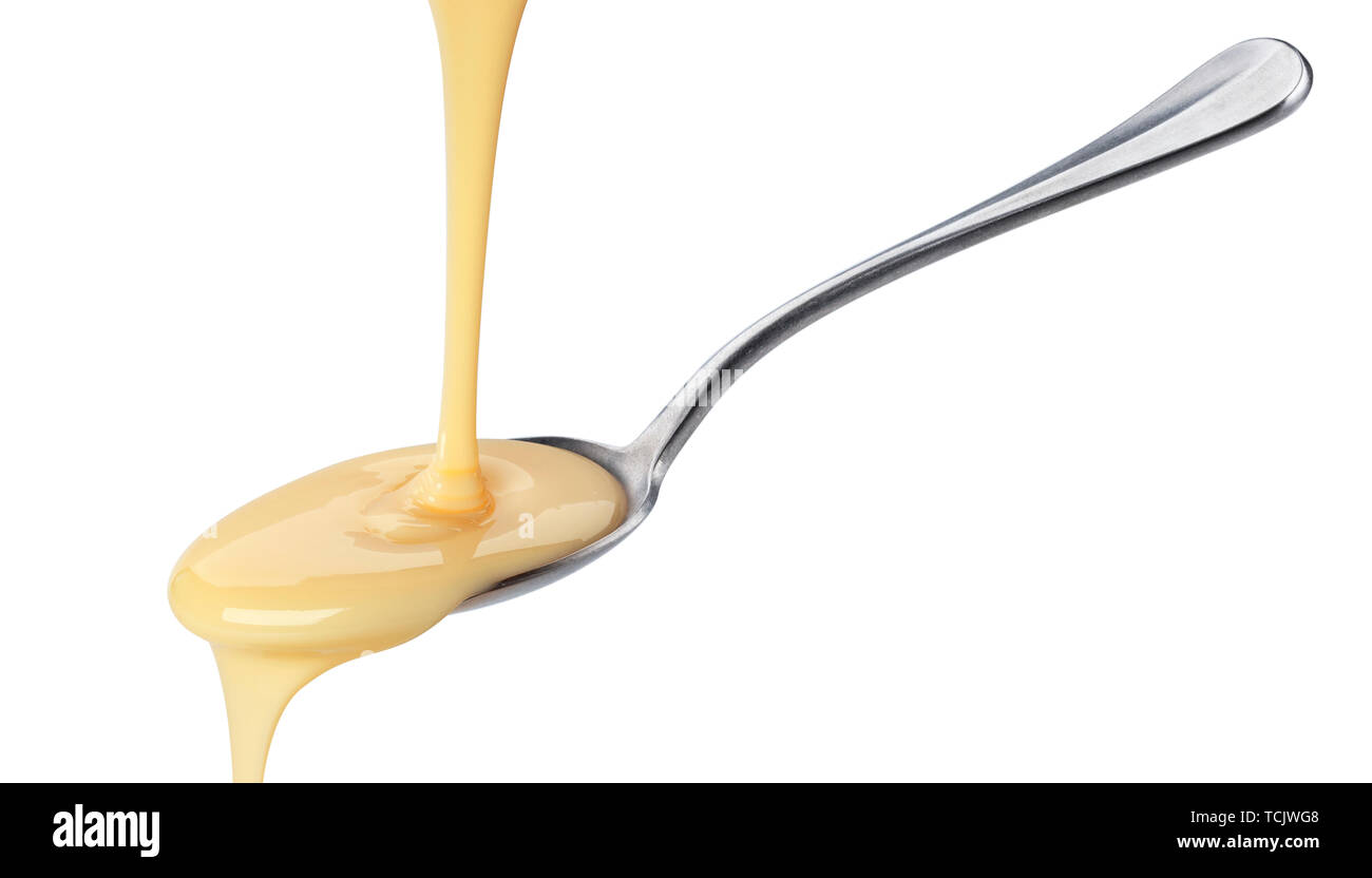 Pouring condensed milk isolated on white background Stock Photo