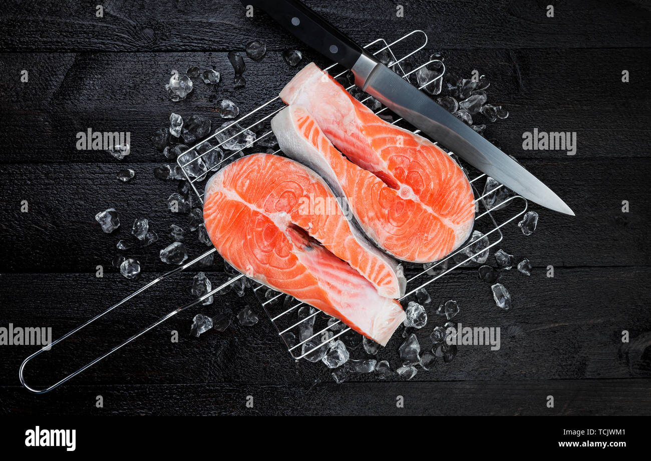 Fresh salmon steak on black background, top view Stock Photo