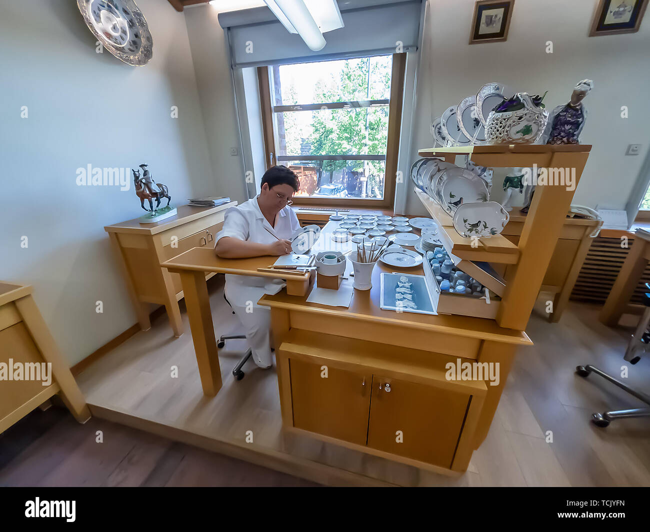 Artisan working in a porcelain piece in Herend Porcelain Manufacture