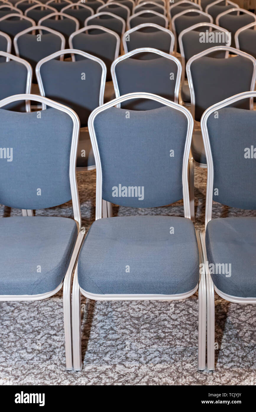 Group of empty blue chairs in modern conference hall - presentation room for seminars Stock Photo