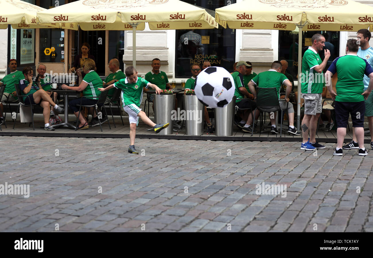 A young Northern Ireland fan plays football before the UEFA Euro 2020 Qualifying, Group C match at A. Le Coq Arena, Tallinn. Stock Photo