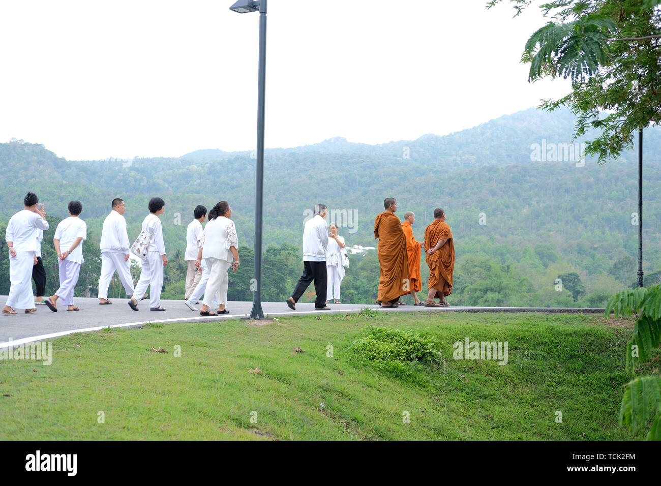 Chiang Mai, Thailand -  May 29, 2019: buddhist monk and people walking for meditation in Chiang Mai university in Chiang Mai, Thailand on May 29, 2019 Stock Photo