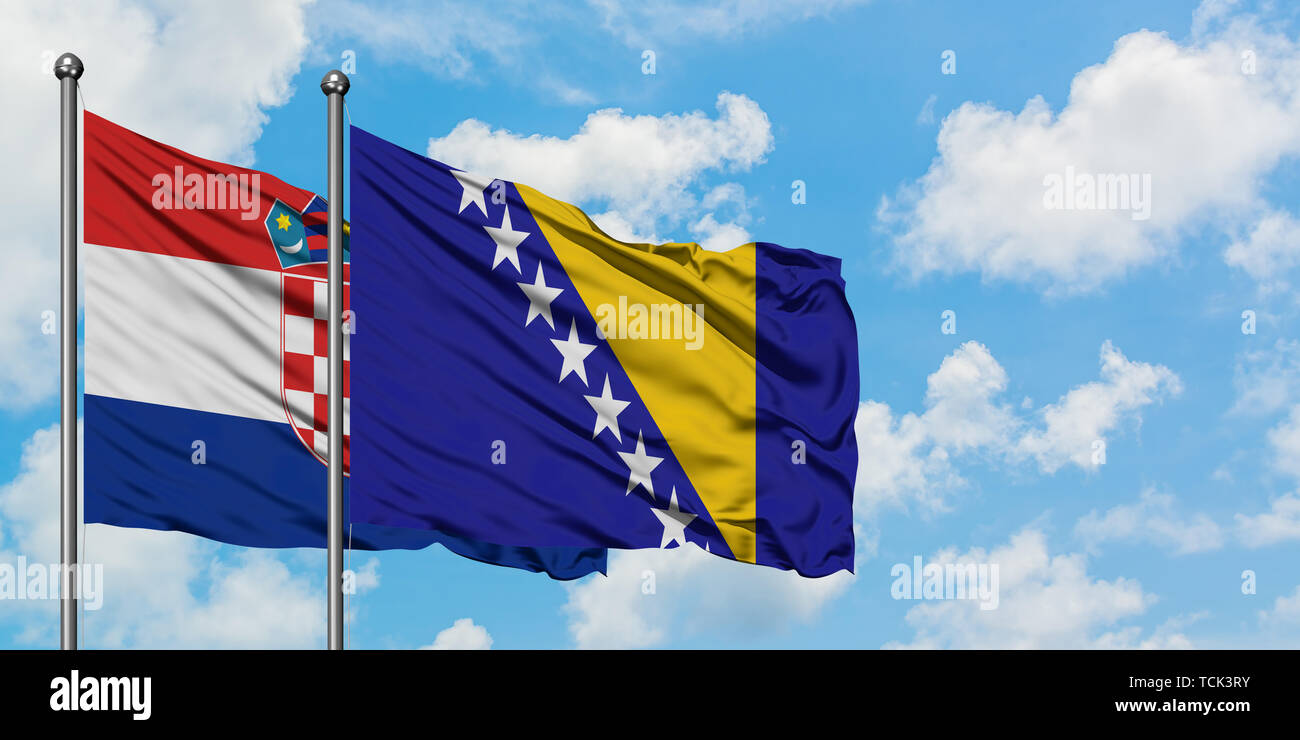 Croatia and Bosnia Herzegovina flag waving in the wind against white cloudy blue sky together. Diplomacy concept, international relations. Stock Photo