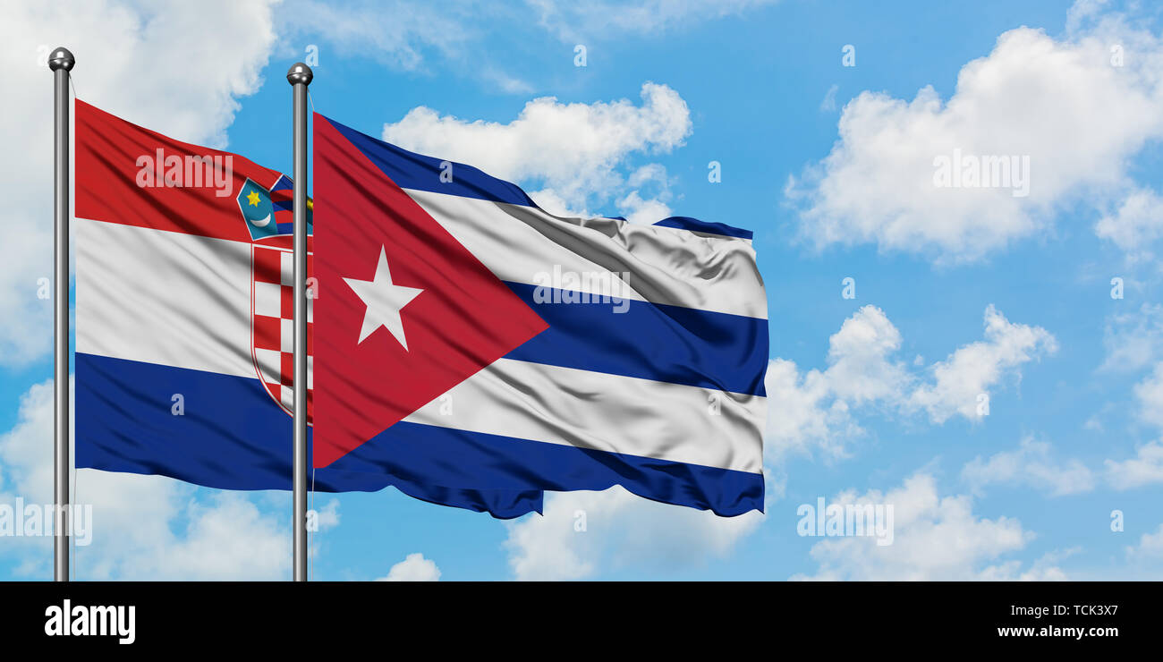 Croatia and Cuba flag waving in the wind against white cloudy blue sky together. Diplomacy concept, international relations. Stock Photo