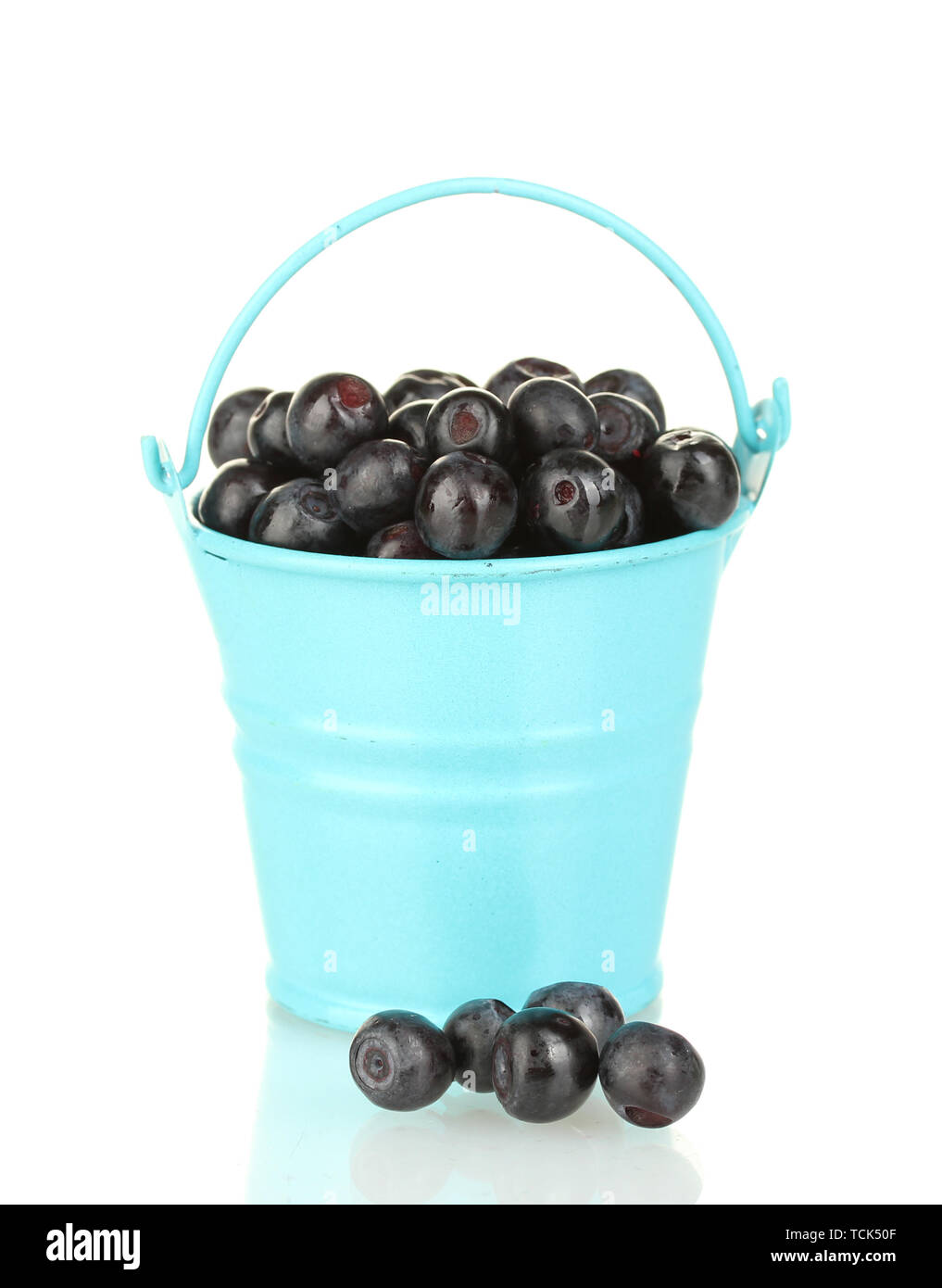 ripe blueberries in blue bucket isolated on white Stock Photo - Alamy