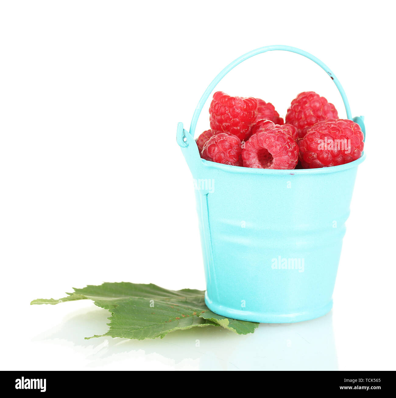 Fresh raspberries in blue bucket isolated on white Stock Photo - Alamy