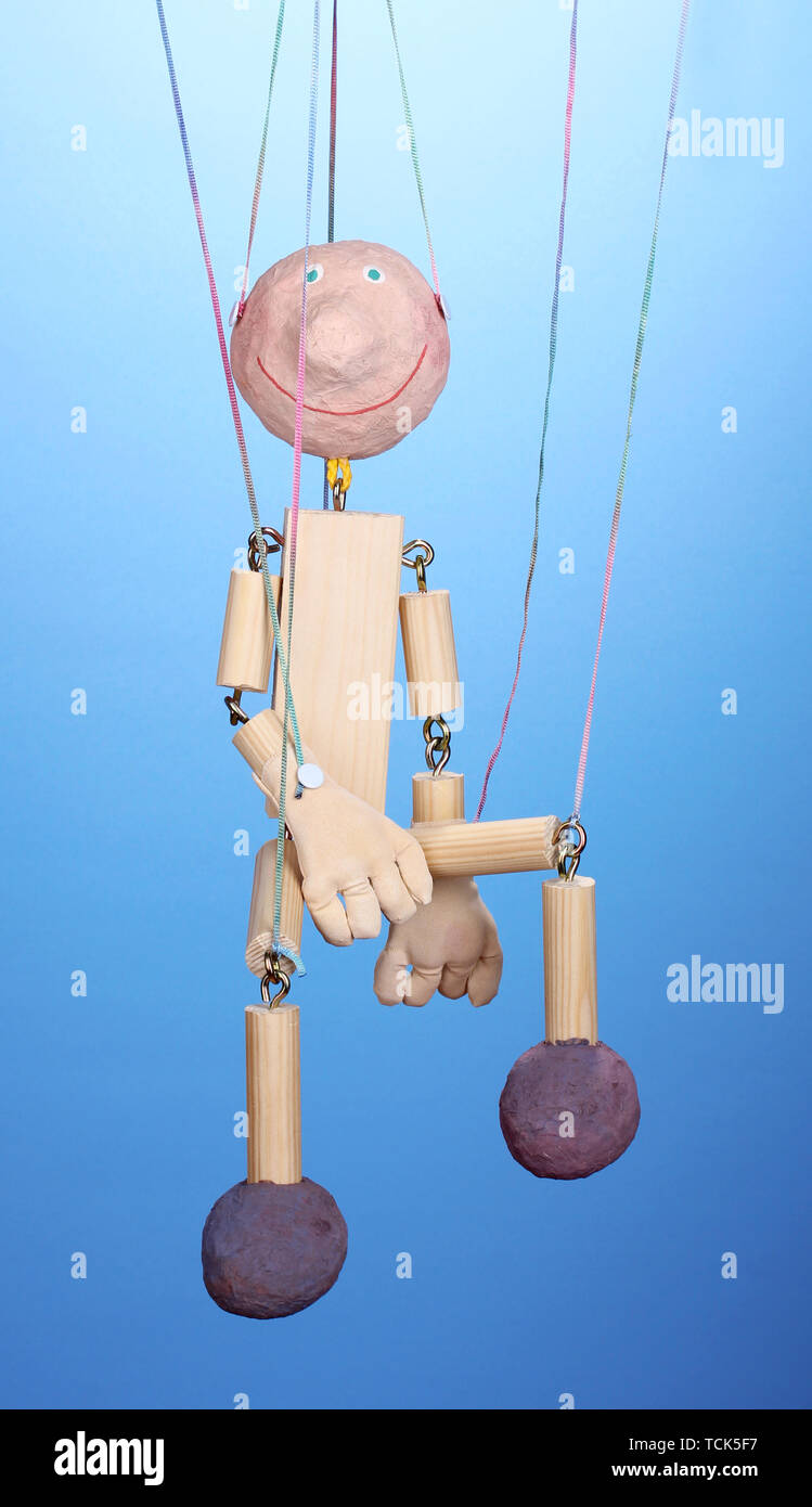 Wooden puppet on blue background Stock Photo - Alamy