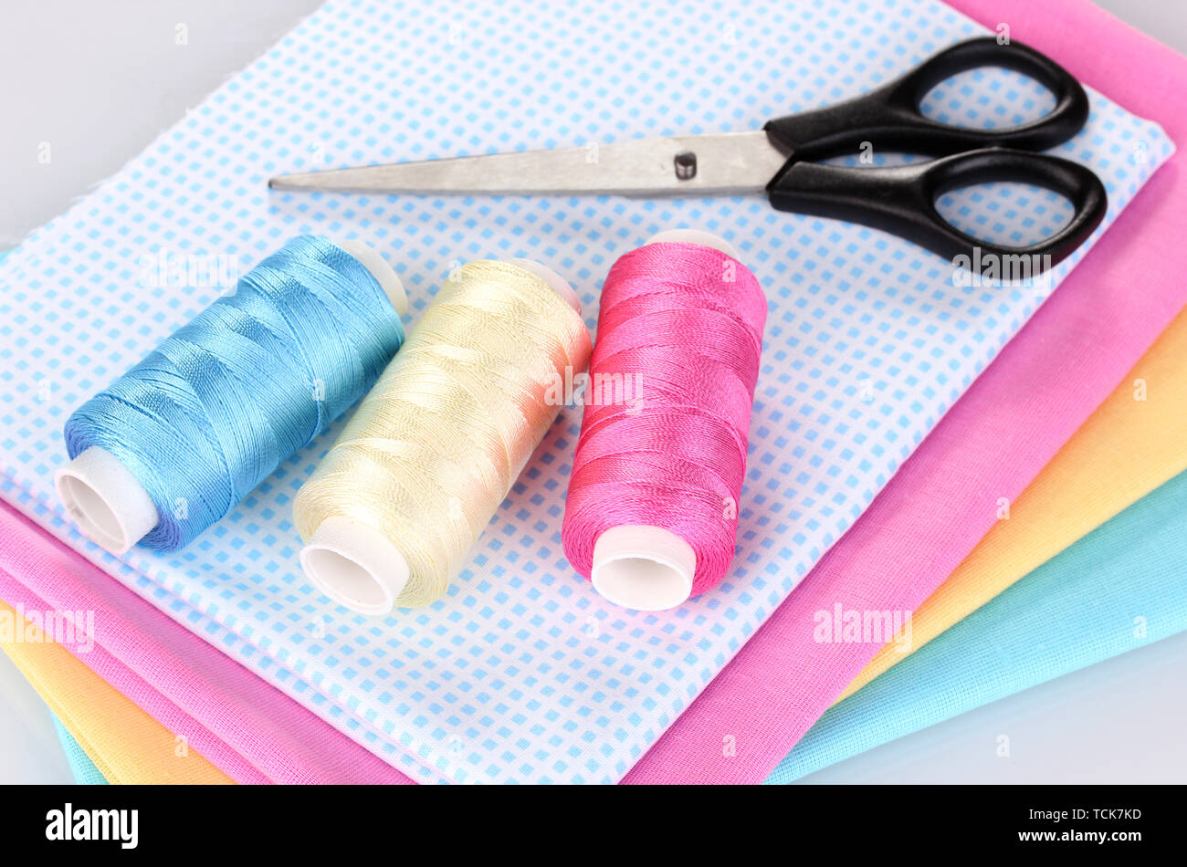 Sewing accessories and fabric isolated on white Stock Photo - Alamy