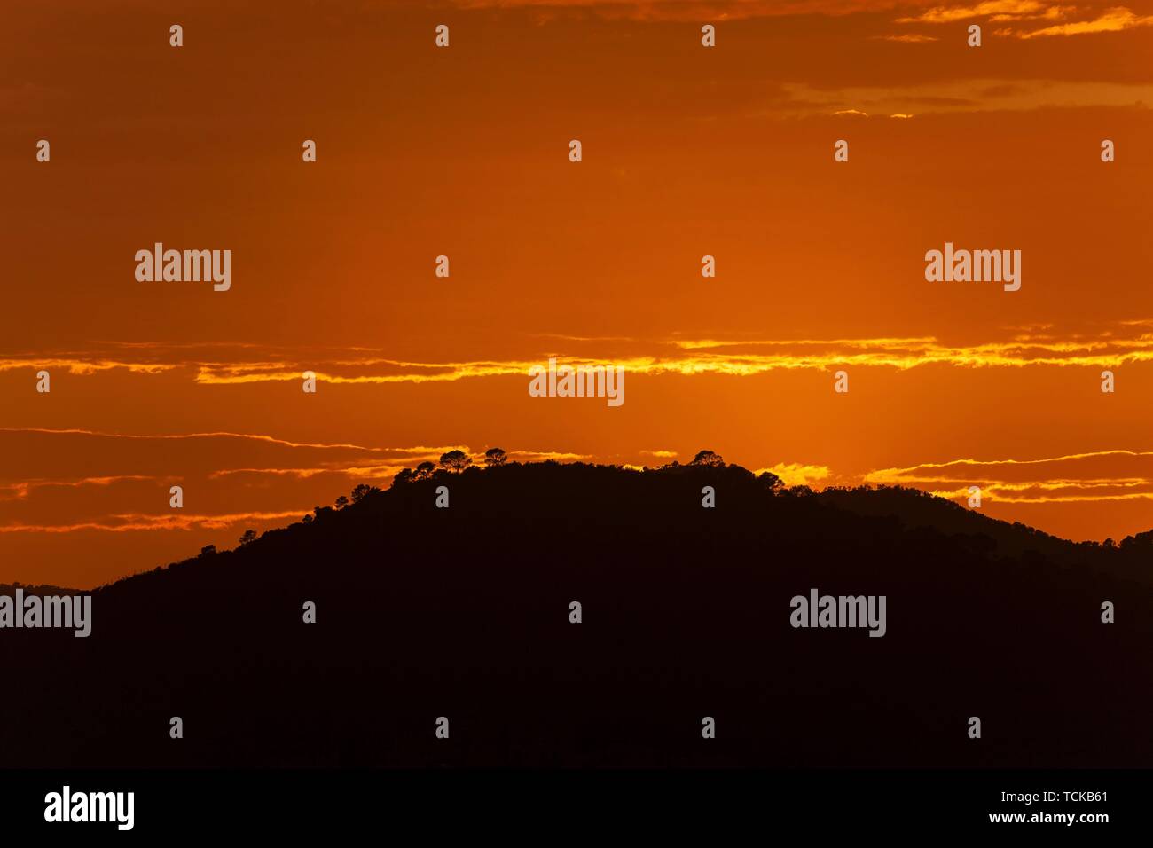 Orange sunset, hill in backlight, near Paguera or Peguera, Majorca, Balearic Islands, Spain Stock Photo