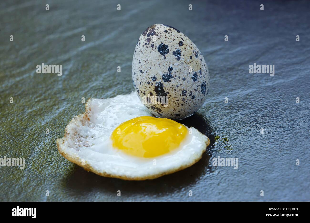 Quail egg and fried egg, Germany Stock Photo