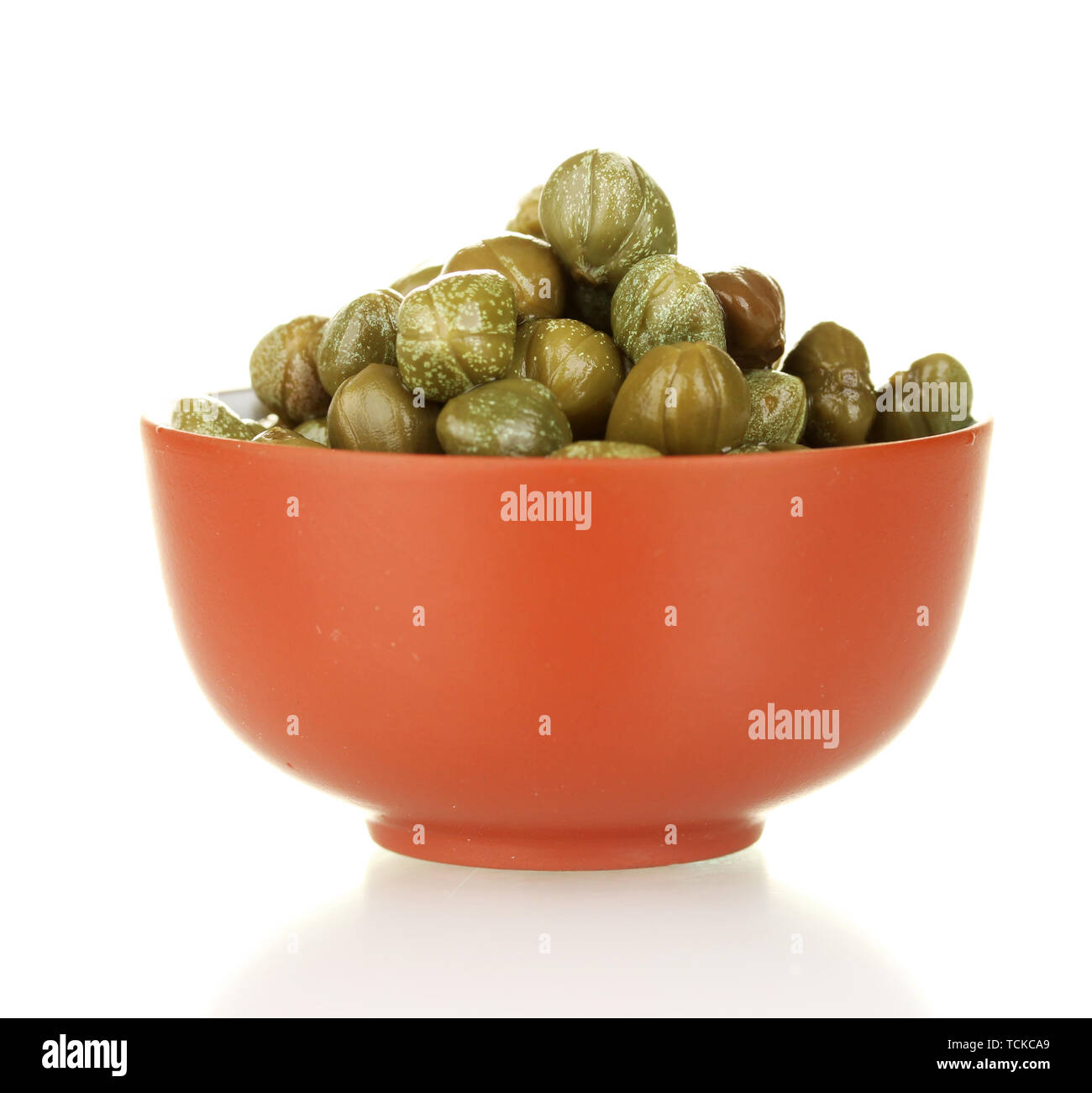 green capers in ceramical bowl isolated on white background Stock Photo