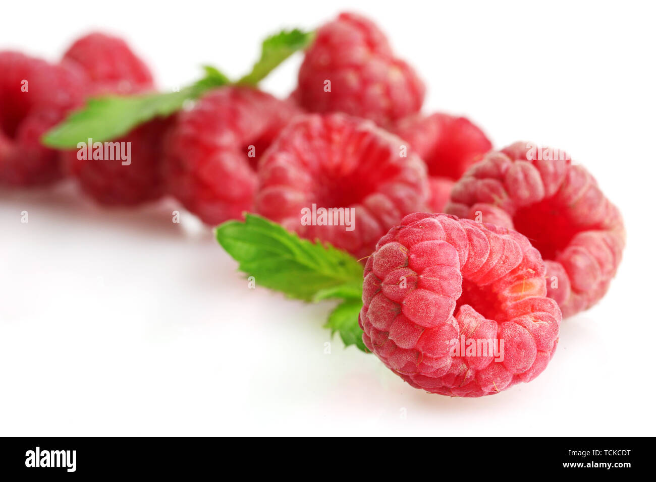 ripe raspberries with mint isolated on white Stock Photo - Alamy