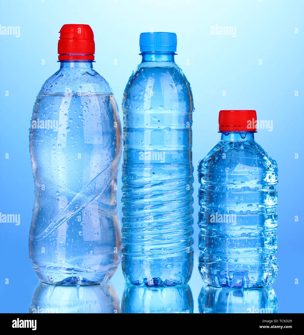 plastic bottles of water on blue background Stock Photo - Alamy