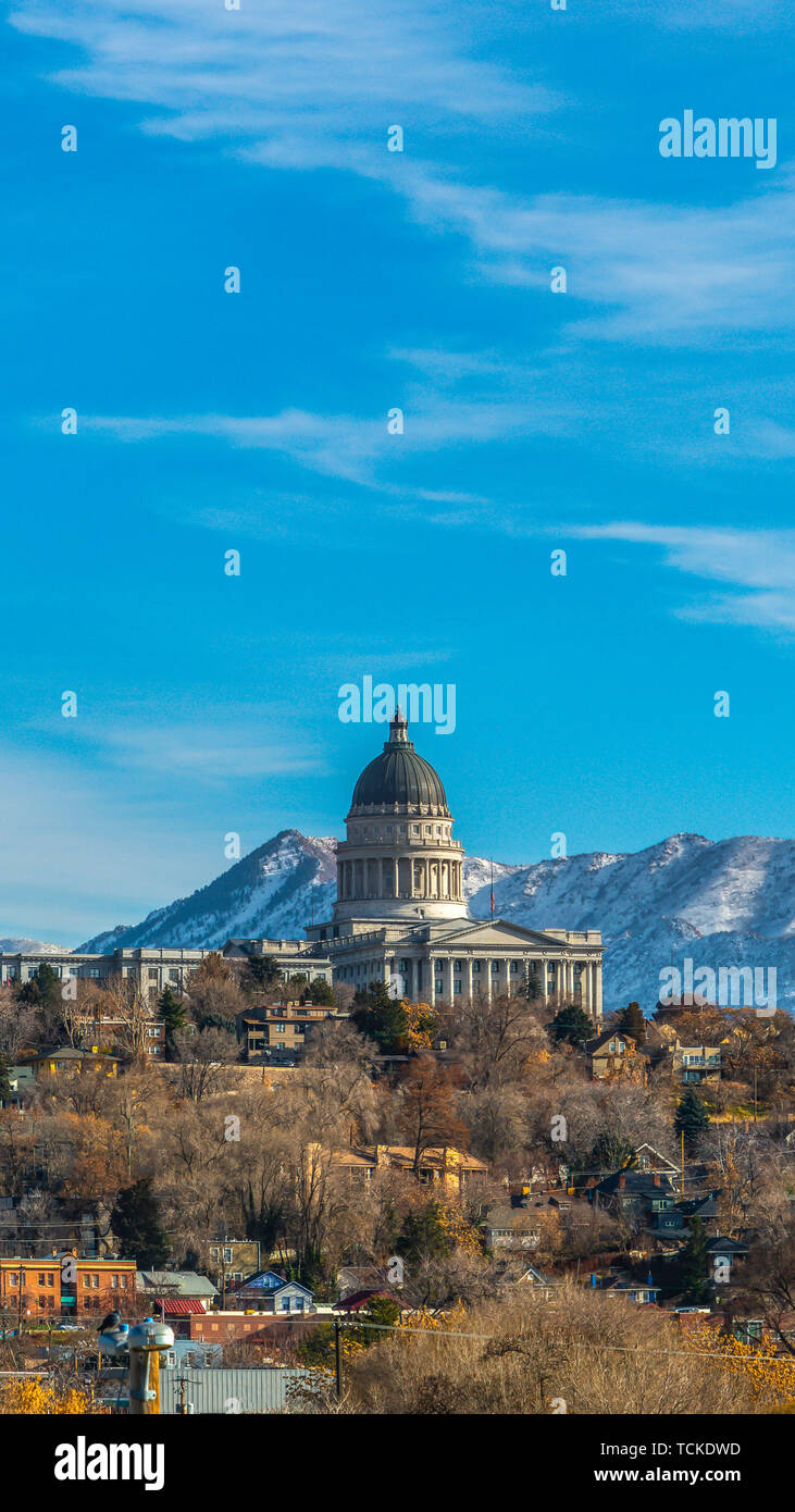 Panorama frame The majestic Utah State Capital Building towering over houses in Salt Lake City Stock Photo