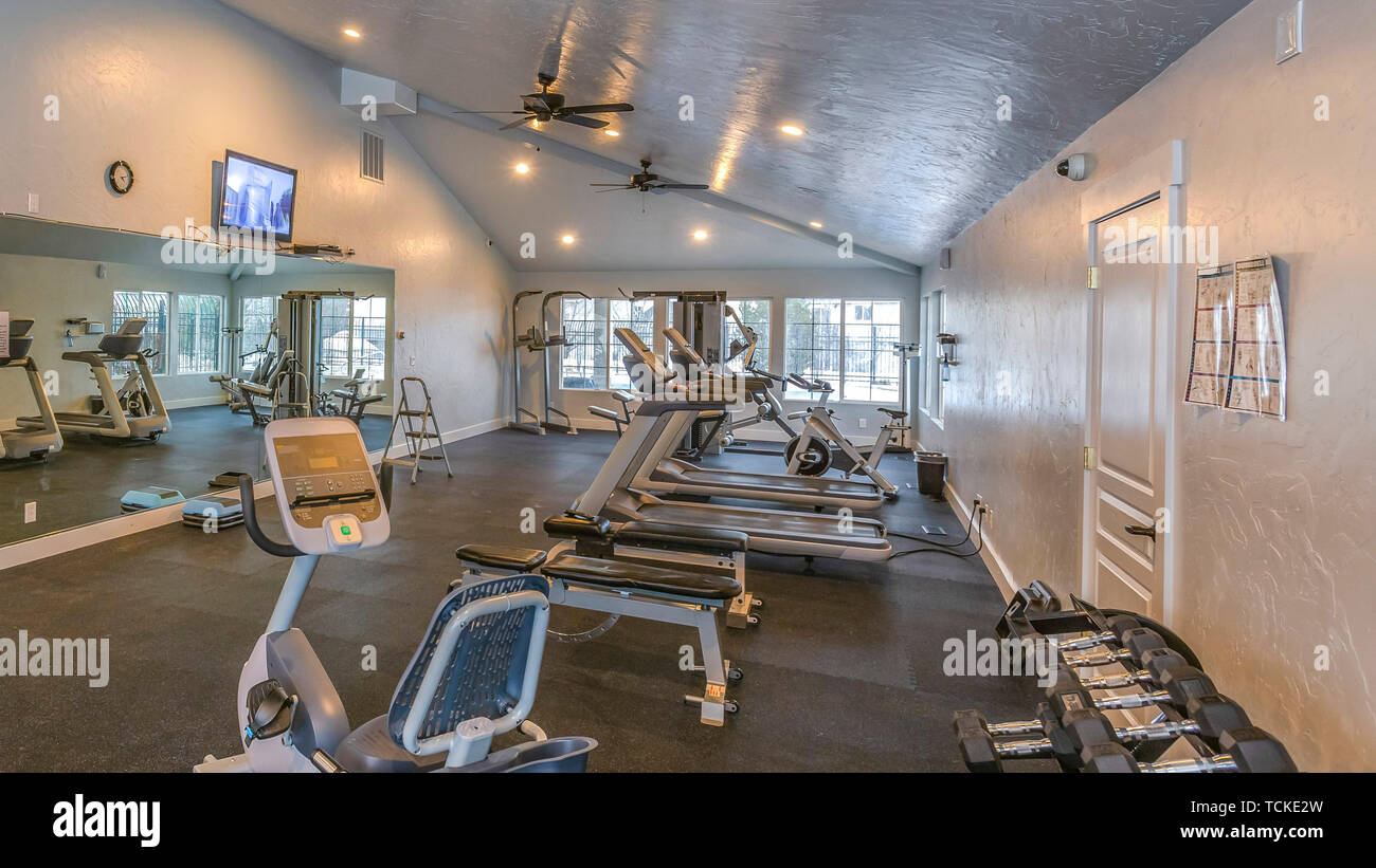 Panorama Interior of a spacious fitness gym with various exercise equipment Stock Photo