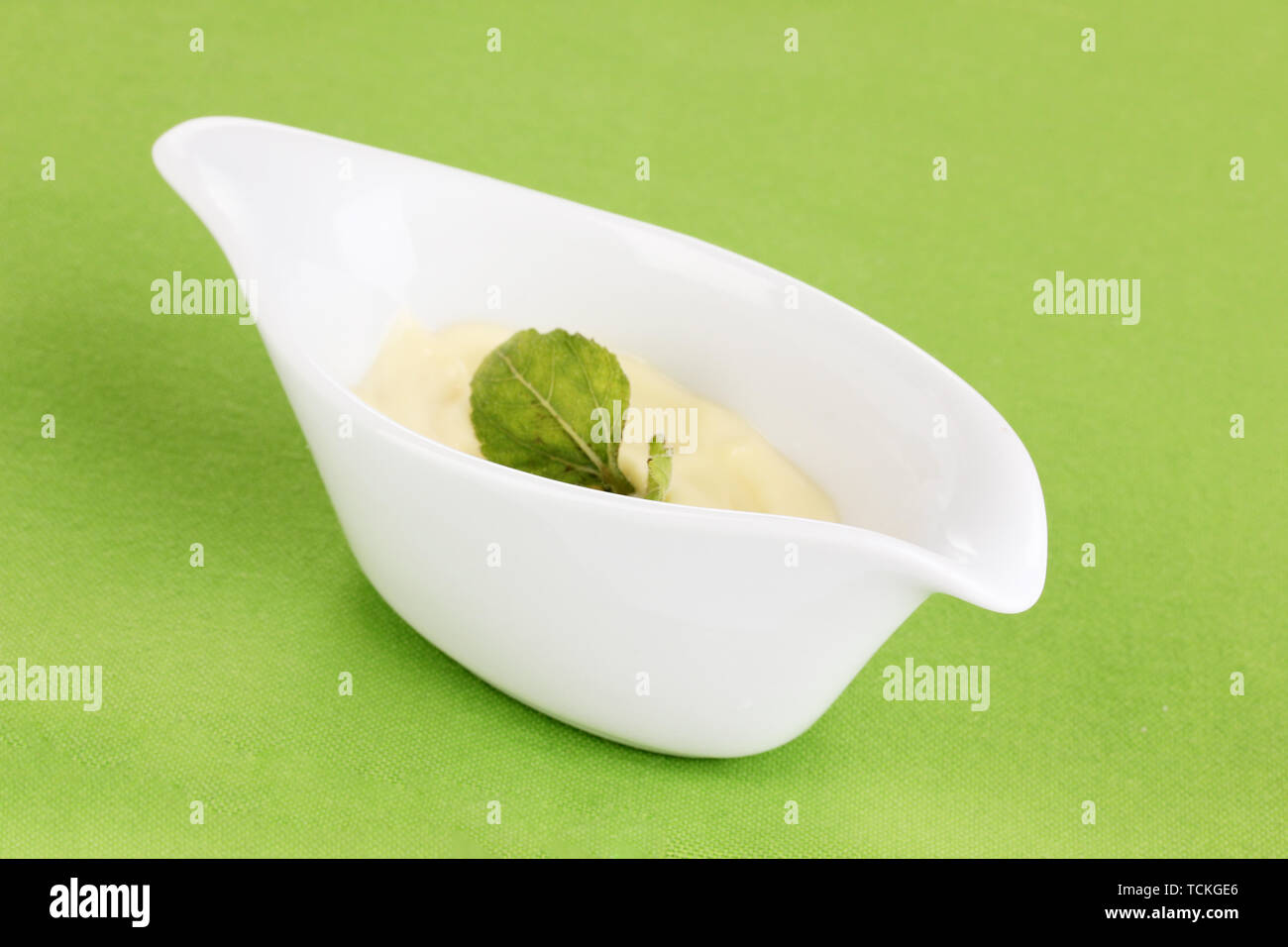 Mayonnaise in bowl on napkin isolated on white Stock Photo