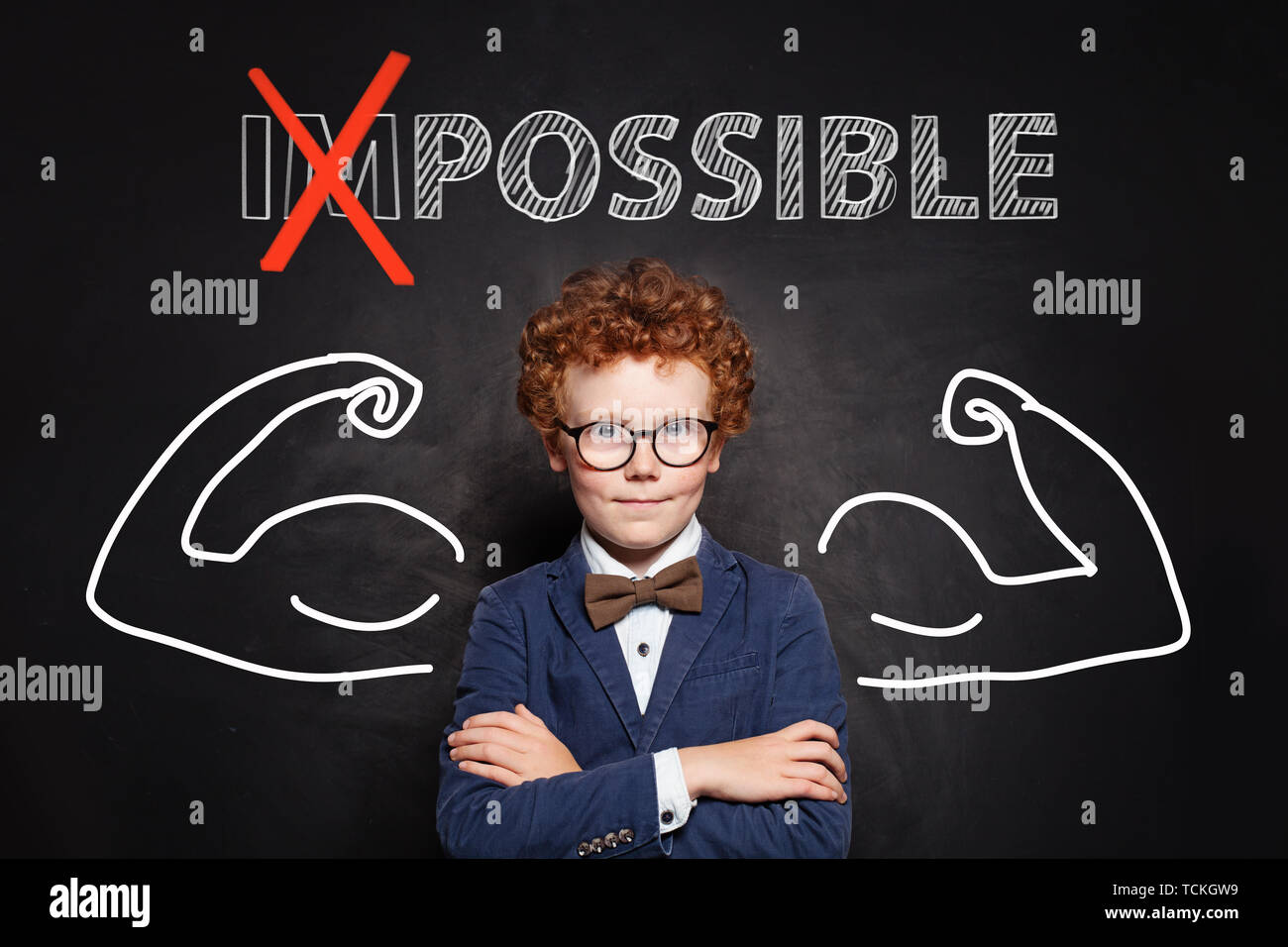 Confident smart kid with text possible on chalkboard background. Success and develop concept Stock Photo