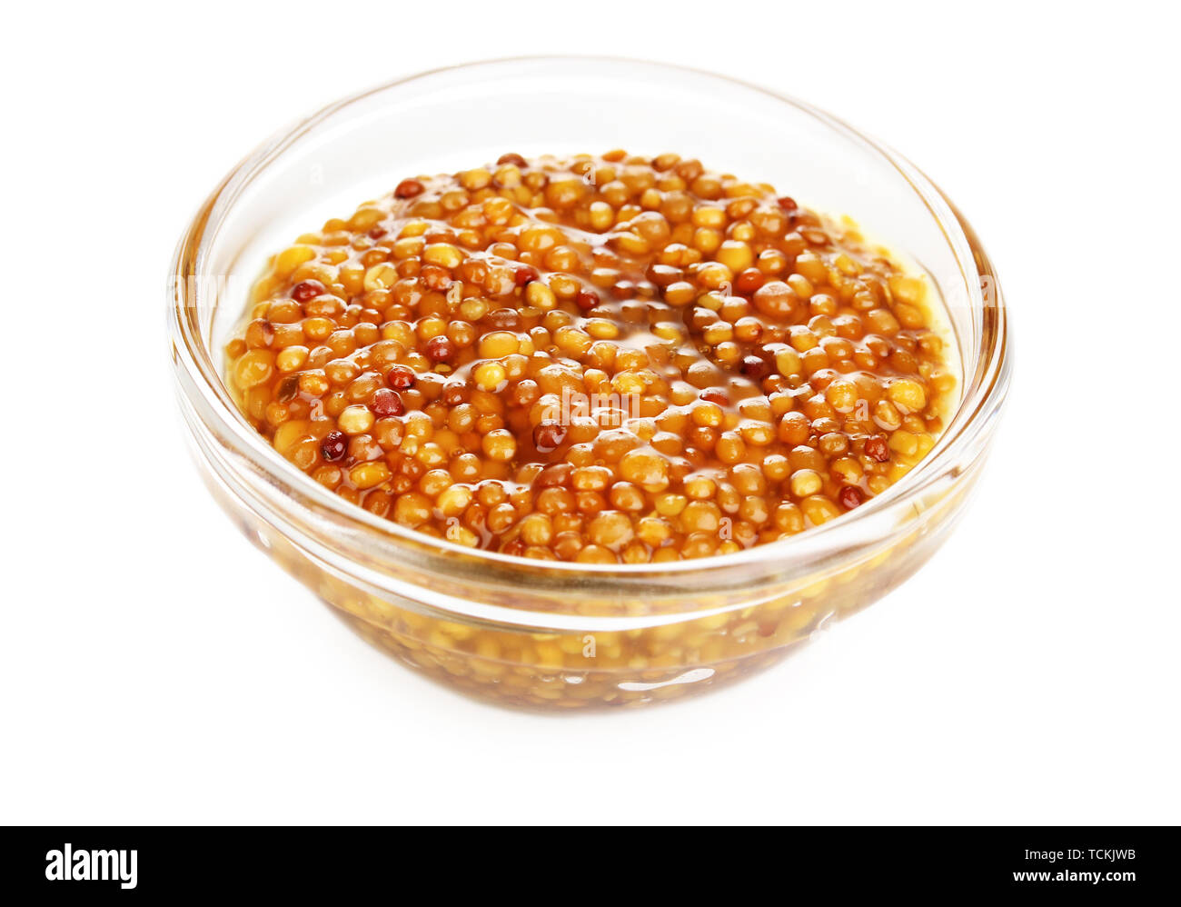 Mustard in grains in glass bowl isolated on white Stock Photo Alamy