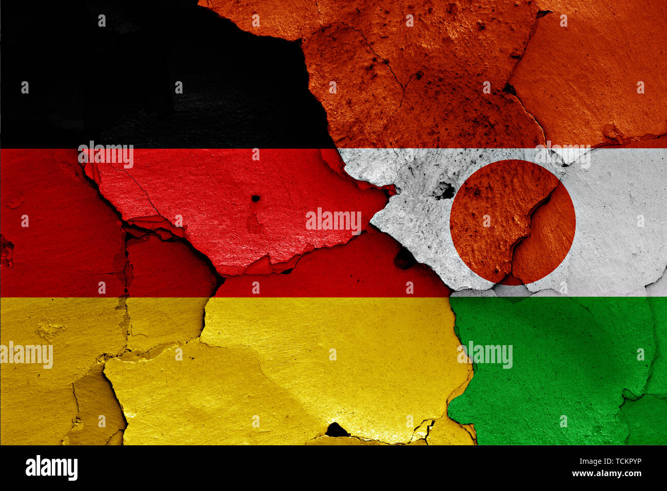 flags of Germany and Niger painted on cracked wall Stock Photo