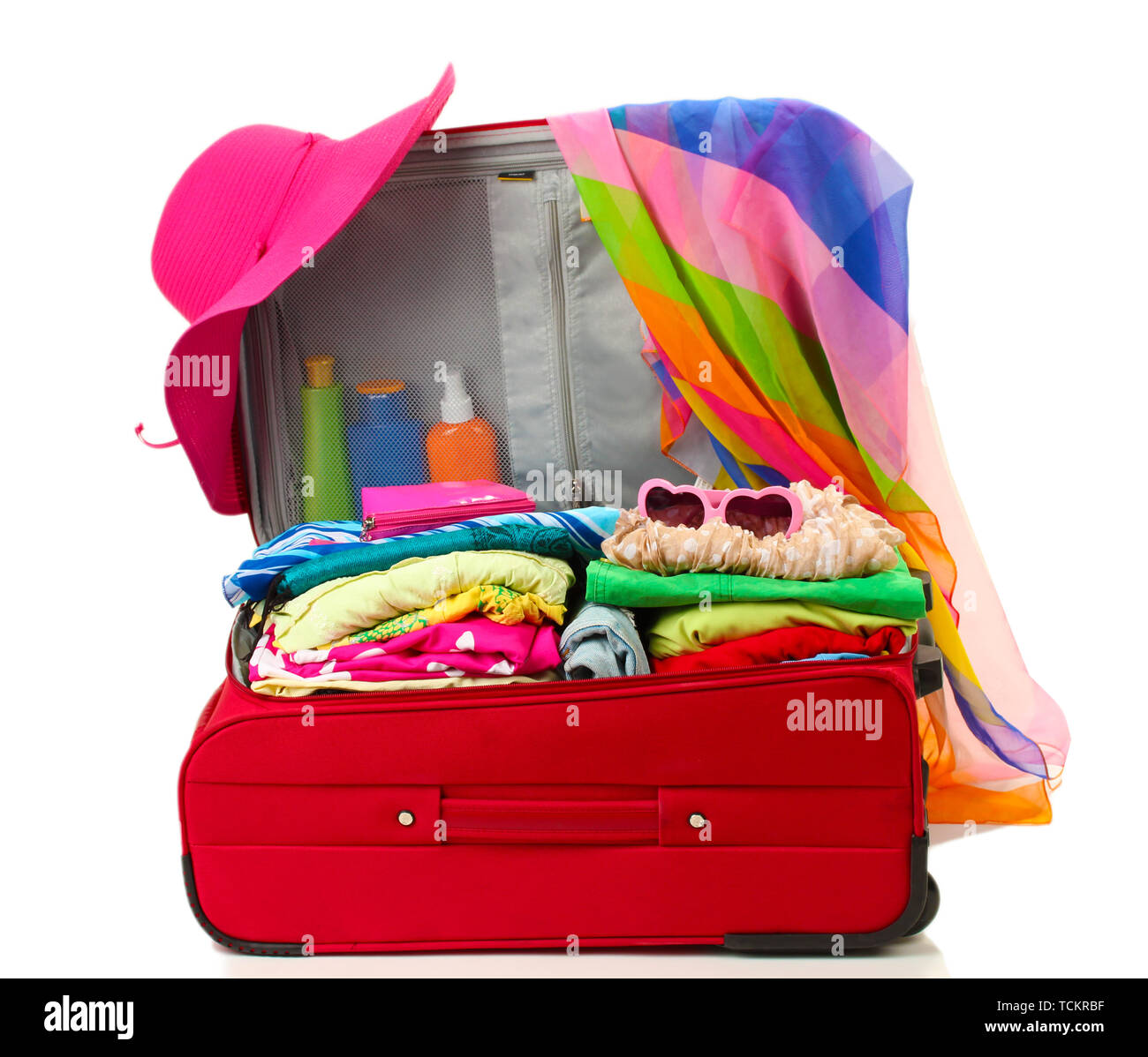 Red travel suitcase with personal belongings isolated on white Stock Photo