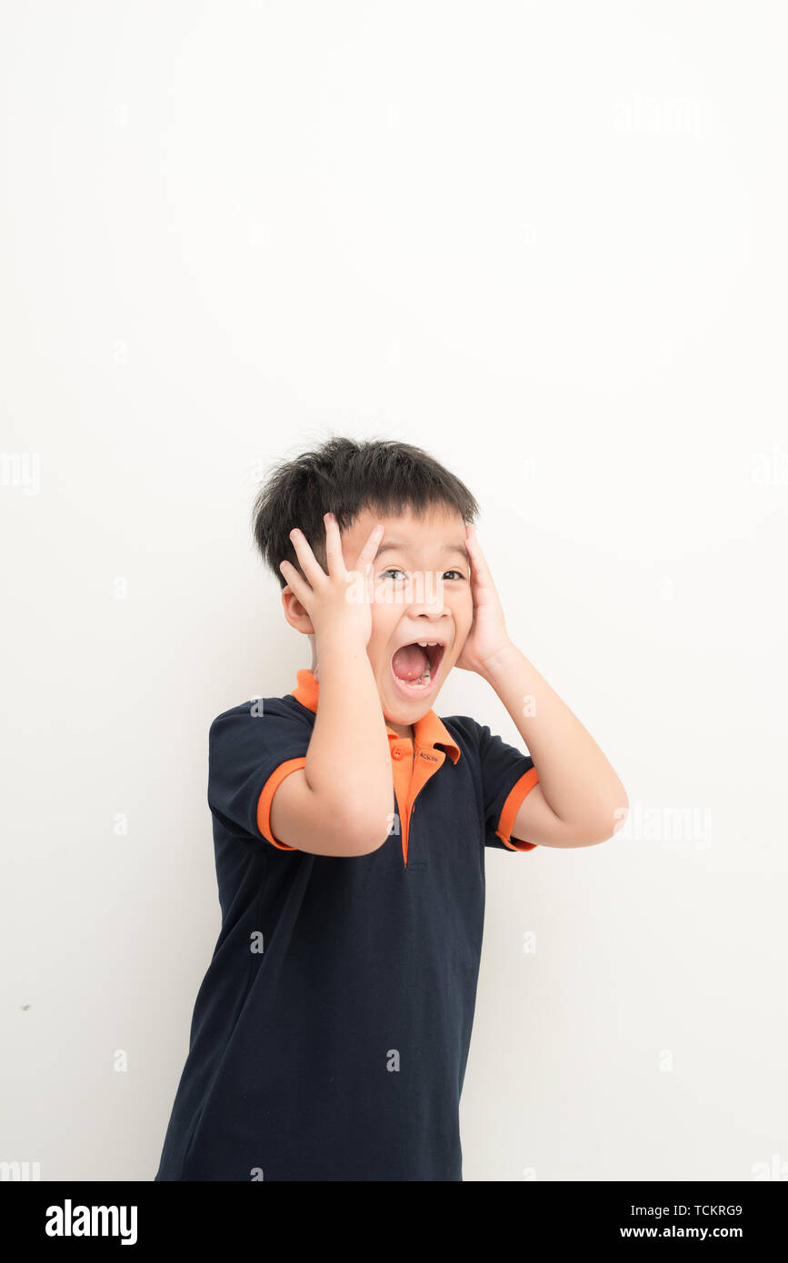 Cute little boy covering ears with hands, on white background Stock Photo