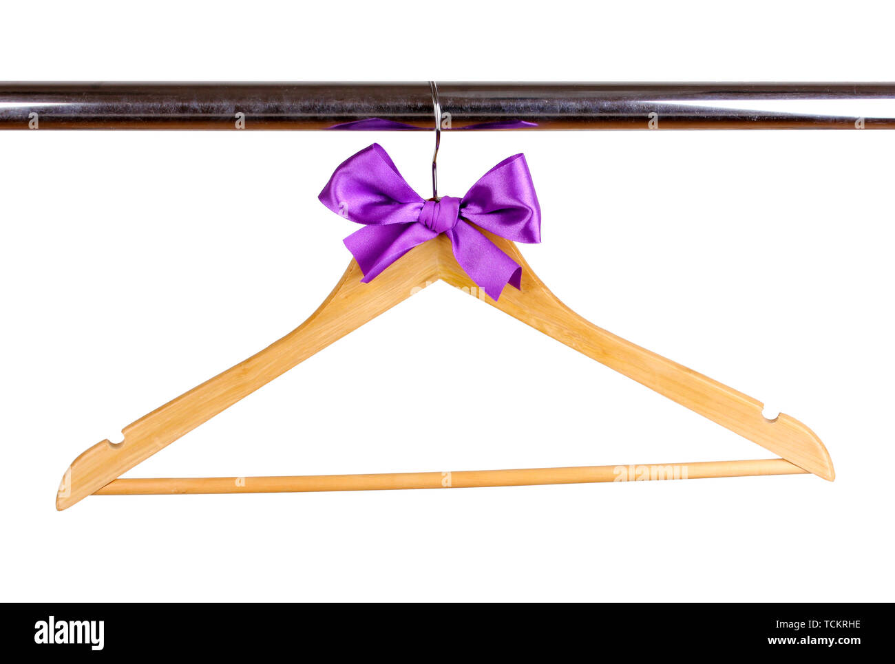 Beautiful purple bow hanging on wooden hanger isolated on white Stock Photo