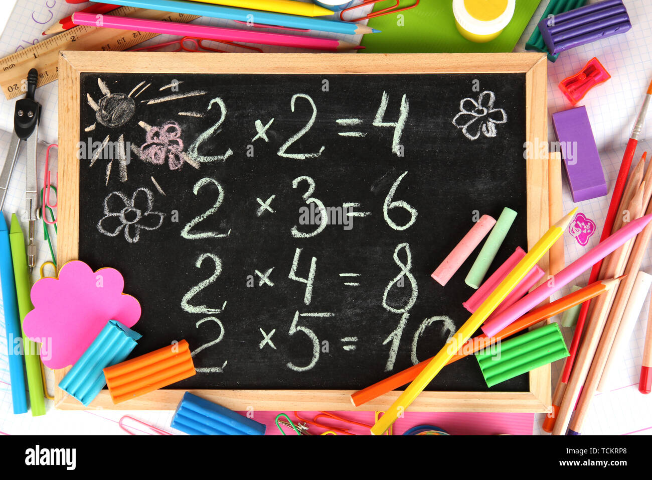 Small school desk with various school supplies closeup isolated on white Stock Photo Alamy