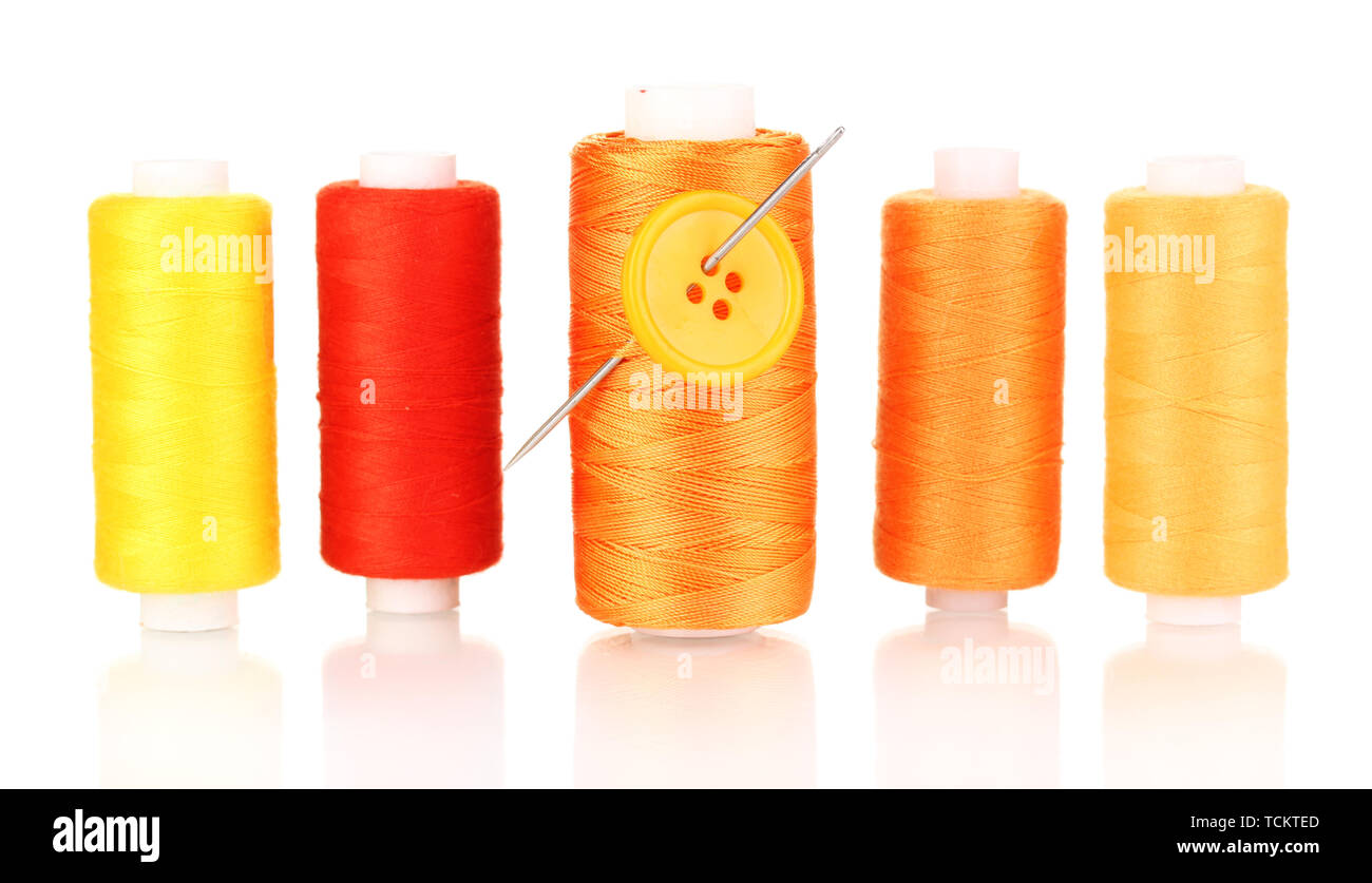 Many yellow bobbin with needle and buttons isolated on white Stock ...
