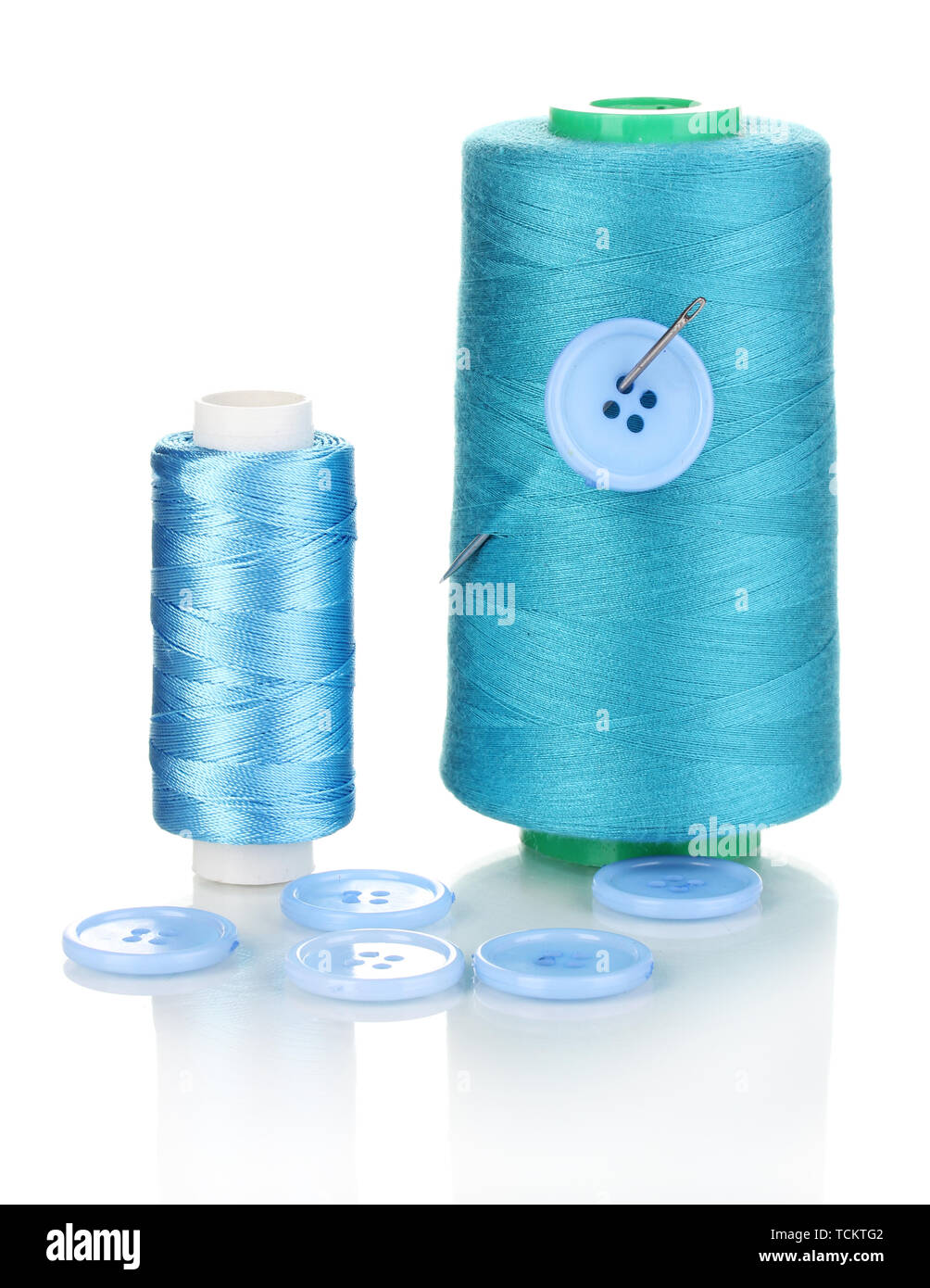 Blue bobbin with needle and buttons isolated on white Stock Photo - Alamy