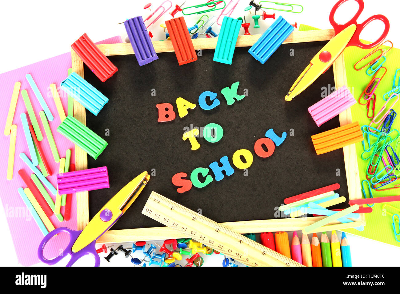 Small chalkboard with school supplies on white background. Back to ...