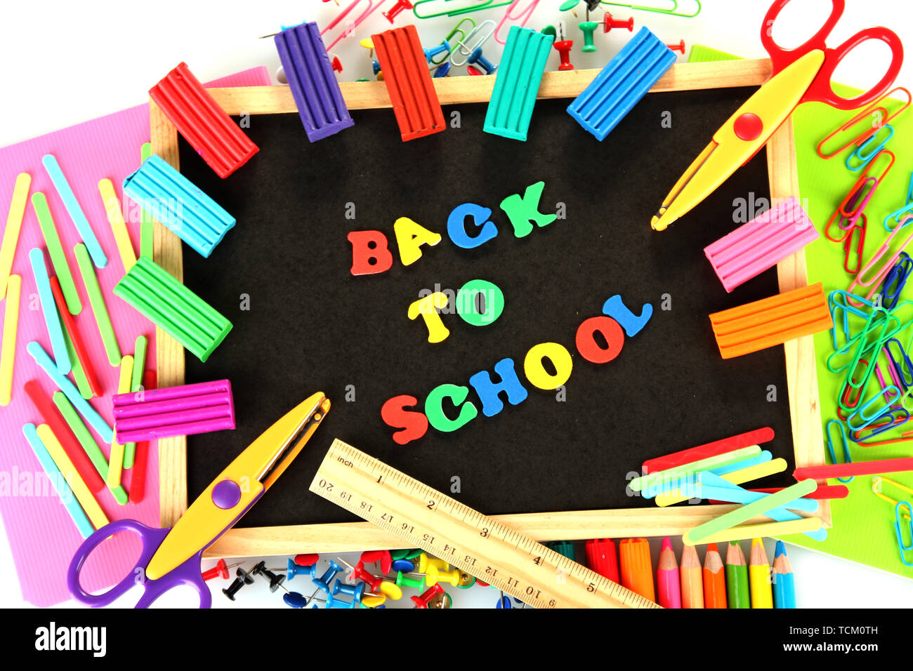 Small chalkboard with school supplies on white background. Back to ...