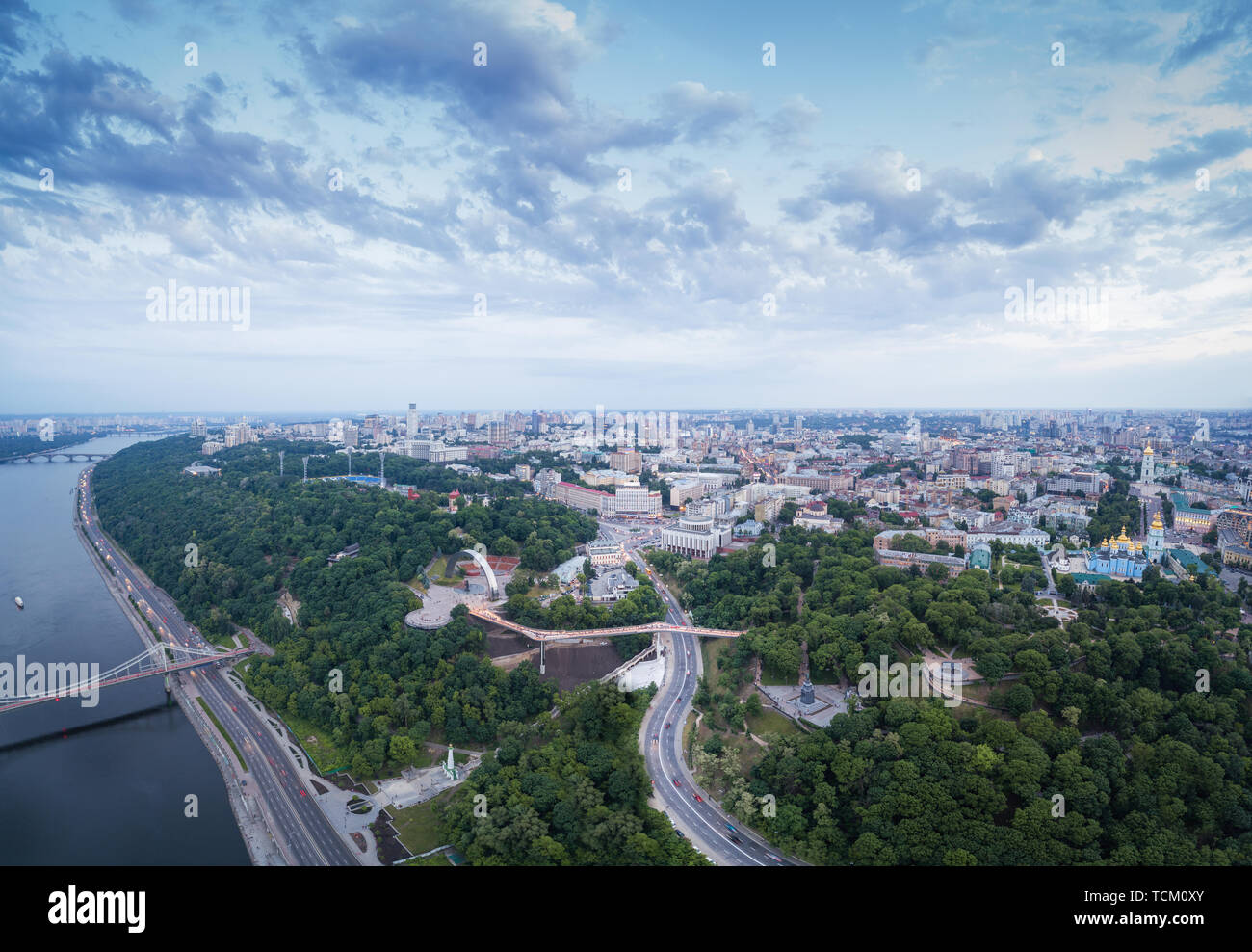 Panoramic aerial view of the city center of Kiev at night near the Arch of Friendship of Peoples with a new glass bridge from Khreschaty Park to Vladi Stock Photo