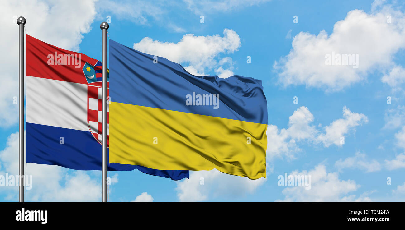 Croatia and Ukraine flag waving in the wind against white cloudy blue sky together. Diplomacy concept, international relations. Stock Photo