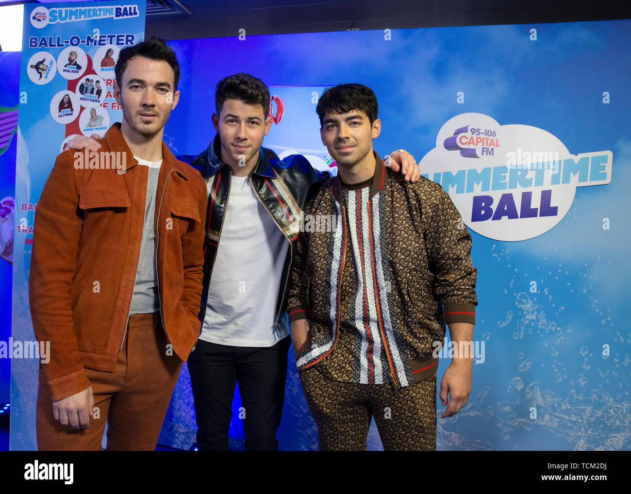 (left to right) Kevin Jonas, Nick Jonas and Joe Jonas of the Jonas Brothers in the on air studio during Capital's Summertime Ball. The world's biggest stars perform live for 80,000 Capital listeners at Wembley Stadium at the UK's biggest summer party. Stock Photo