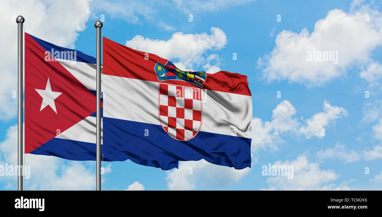 Cuba and Croatia flag waving in the wind against white cloudy blue sky together. Diplomacy concept, international relations. Stock Photo