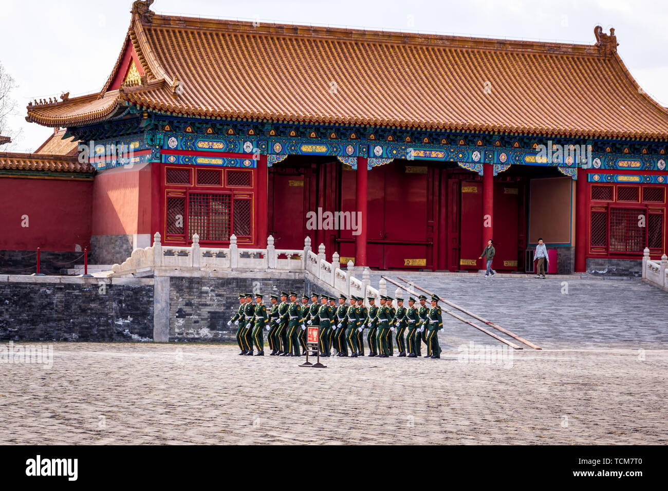 Beijing, China April 2013 Changing of the guard at Forbidden City, soldiers in green uniforms marching in a rectangular formation Stock Photo