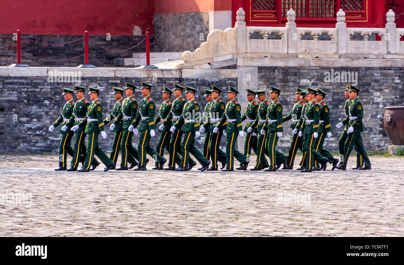 Beijing, China April 2013 Changing of the guard at Forbidden City, soldiers in green uniforms marching in a rectangular formation Stock Photo