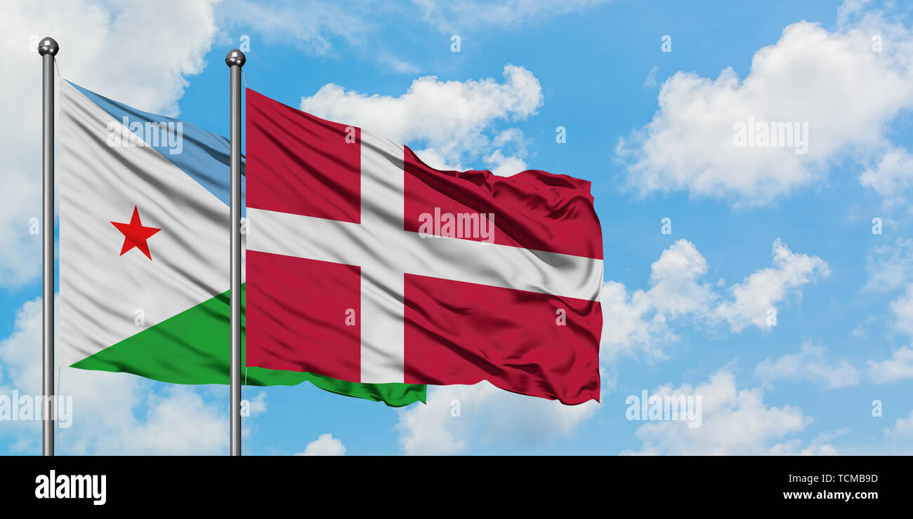 Djibouti and Denmark flag waving in the wind against white cloudy blue sky together. Diplomacy concept, international relations. Stock Photo