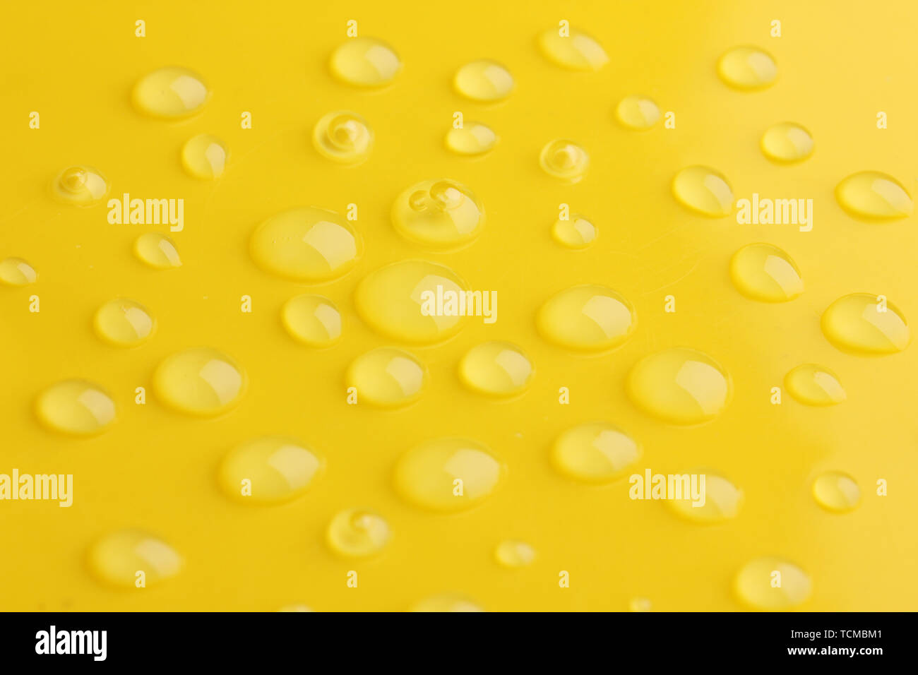 Water drops on yellow background Stock Photo - Alamy