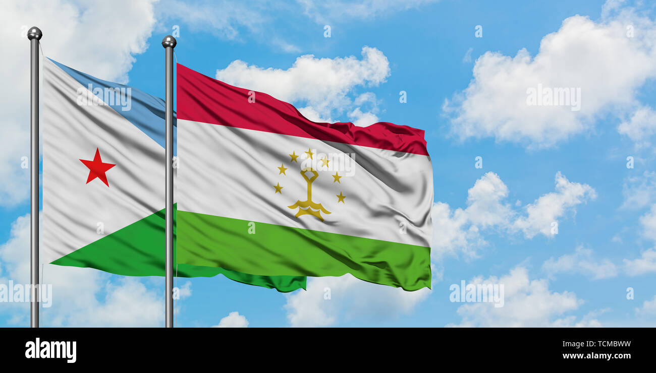 Djibouti and Tajikistan flag waving in the wind against white cloudy blue sky together. Diplomacy concept, international relations. Stock Photo