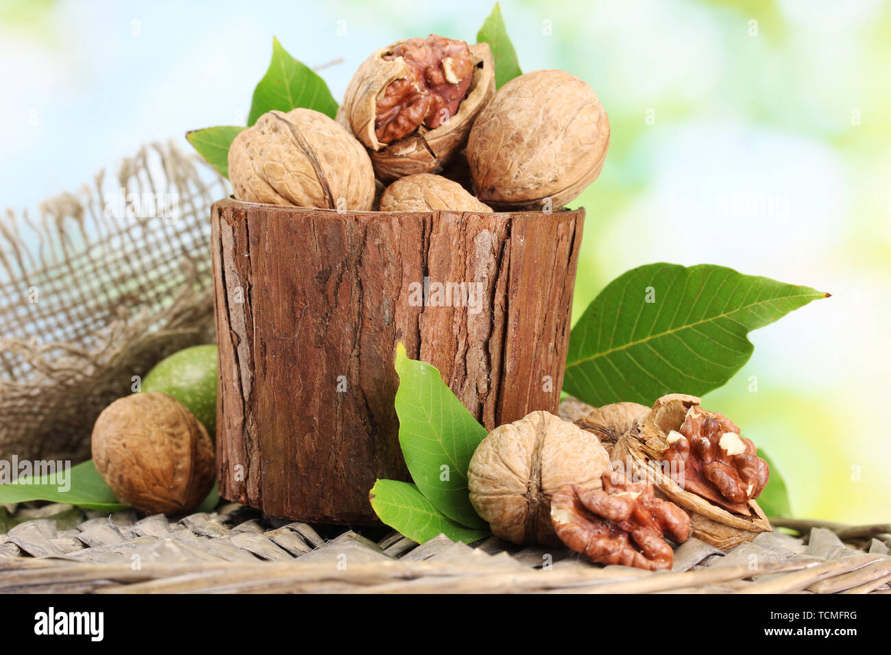 walnuts with green leaves in garden, on green background Stock Photo
