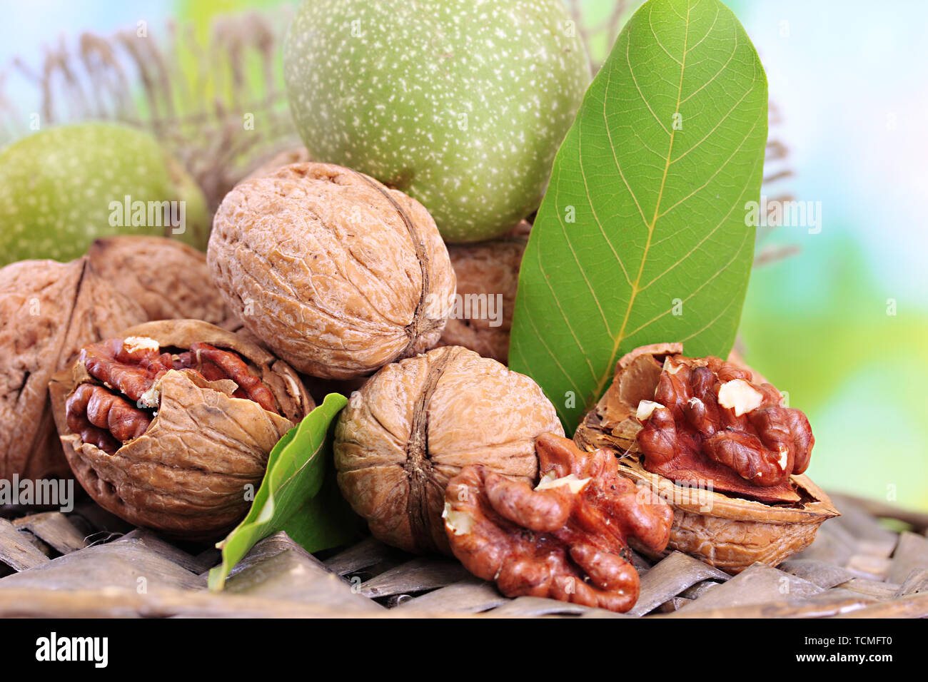 walnuts with green leaves in garden, on green background Stock Photo