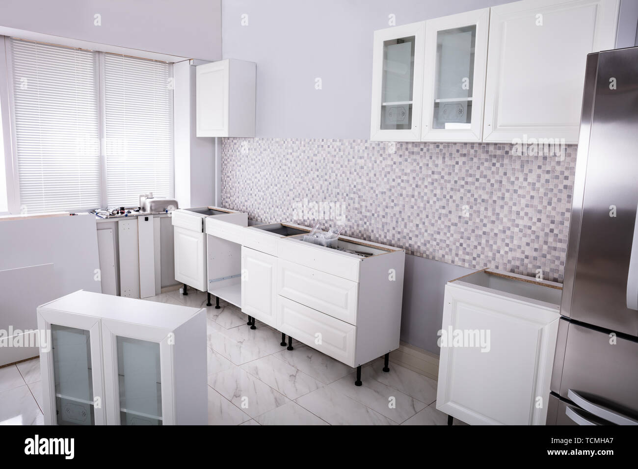 Installation Of Wooden In The White Clean Modular Kitchen