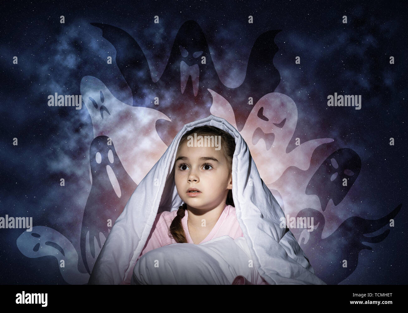 Scared girl with pillow hiding under blanket Stock Photo Alamy
