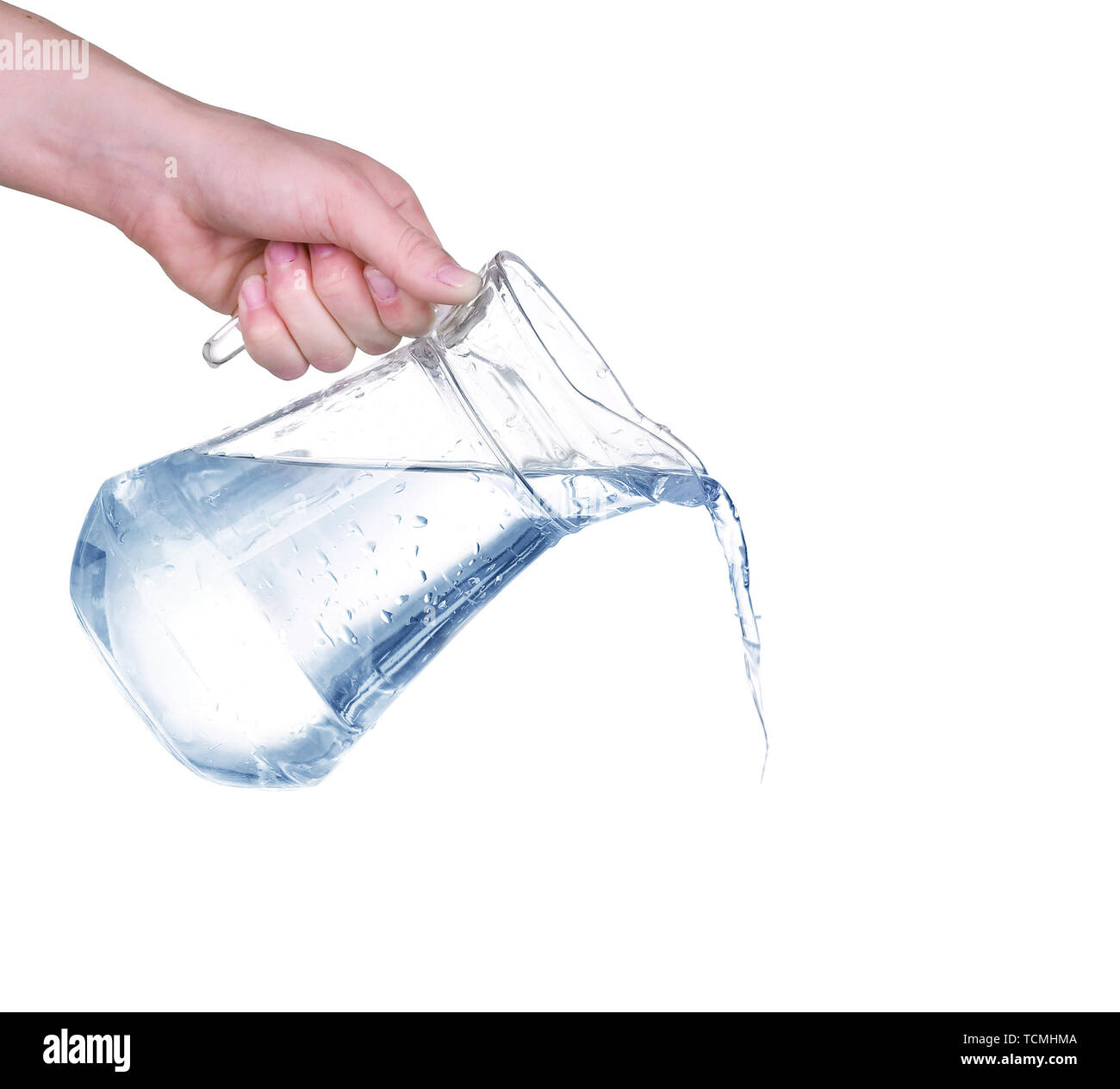 Pouring water from glass pitcher on white background Stock Photo Alamy