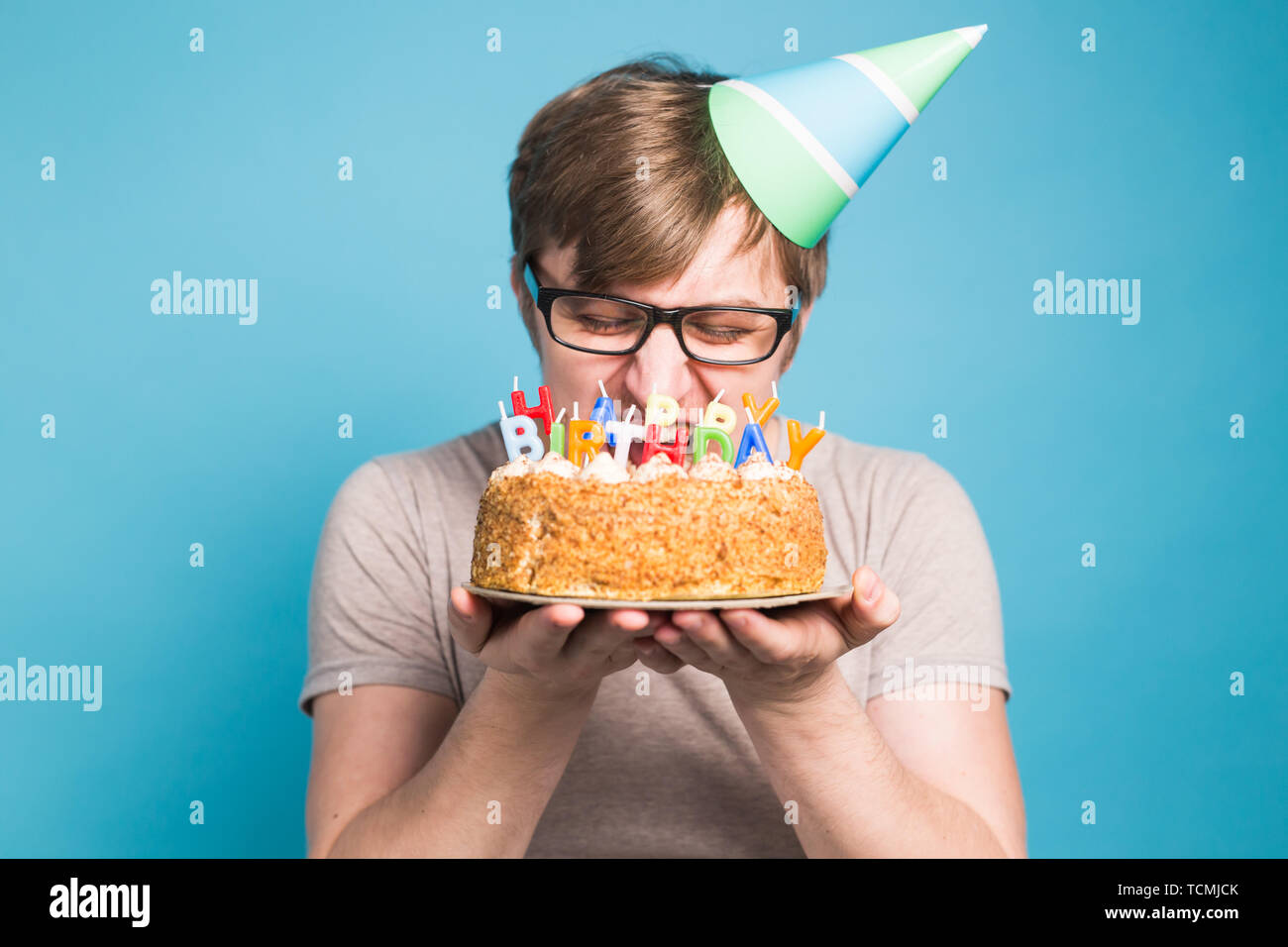 Funny Male In Paper Congratulatory Hat Trying To Bite Off A Cake With A Happy Birthday Candles Stand On A Blue Background Stock Photo Alamy,Toddler Designer Jeans