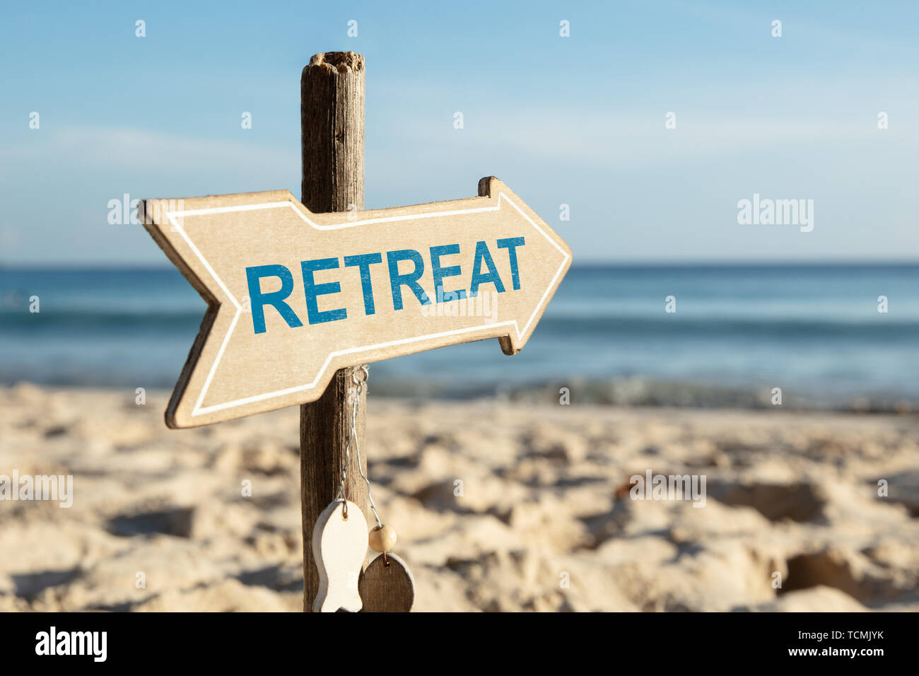 Close-up Of Retreat Directional Arrow Sign Pole On Beach Stock Photo ...