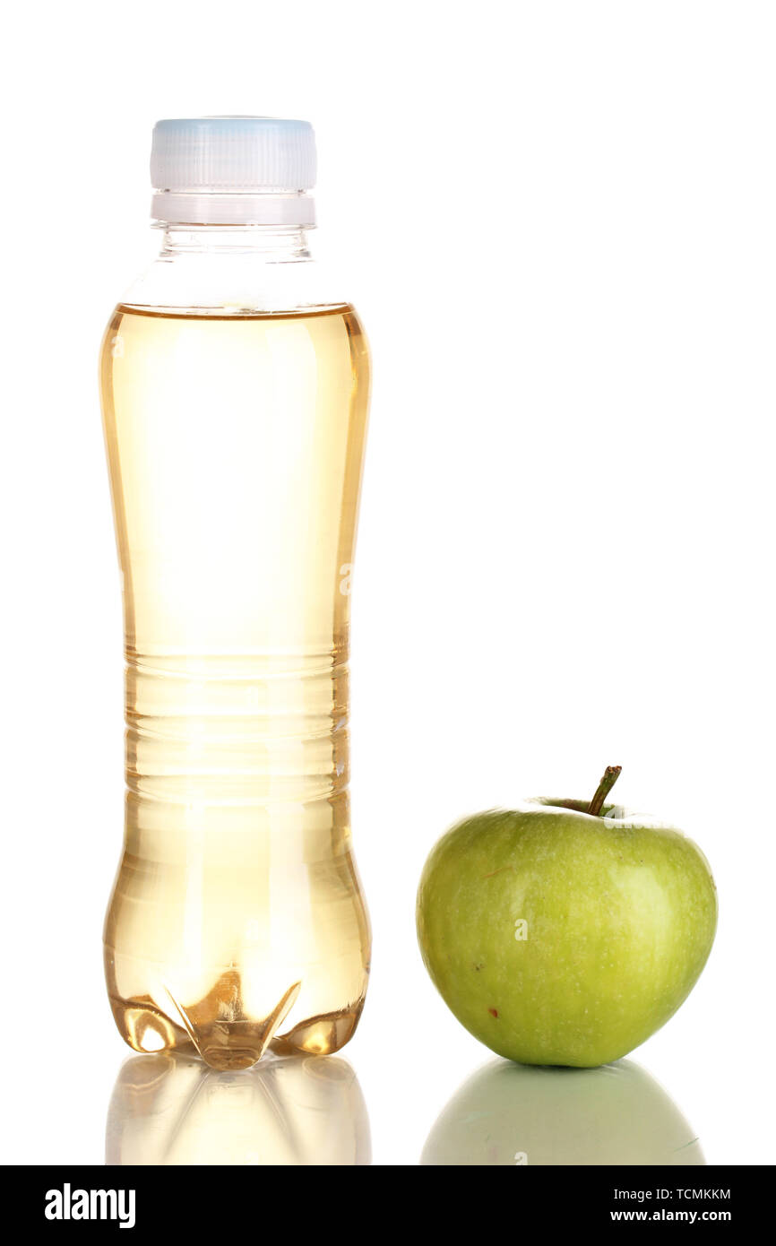 Delicious apple juice in plastic bottle and apple next to it isolated