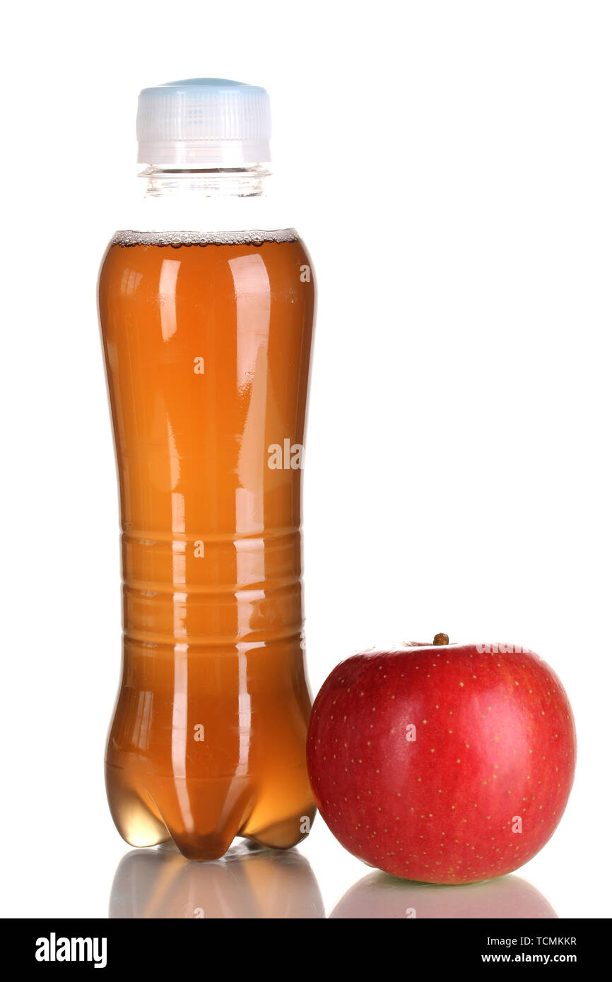 Delicious apple juice in plastic bottle and apple next to it isolated